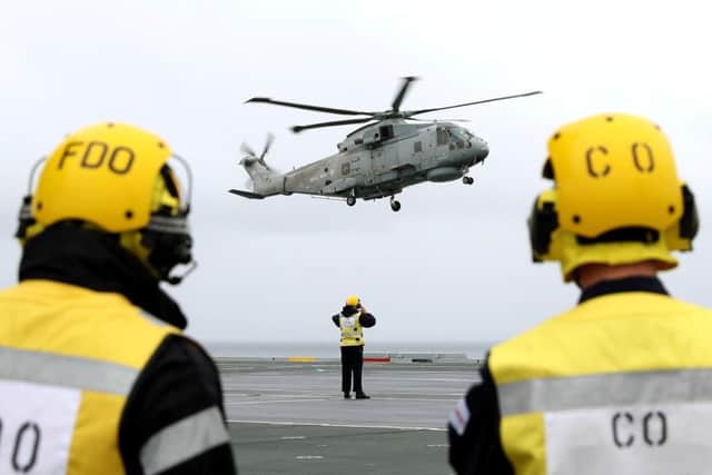 Defence secretary Sir Michael Fallon landing in a helicopter on the desk of HMS Queen Elizabeth, as the Royal Navy's new aircraft carrier sets sail from Lossiemouth for the latest in a series of sea trials on Monday July 24, 2017. Picture: PO PHOT Ray Jones/MoD/PA Wire