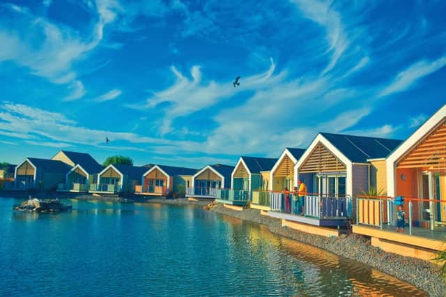 The wooden chalets overlooking the lake at Butlins , Minehead