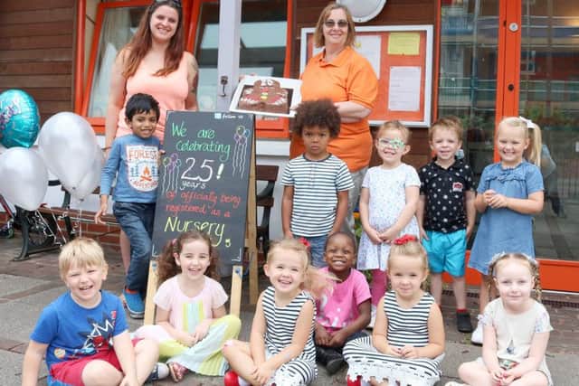Staff Natasha Wells and Helen Marshall with children at the nursery