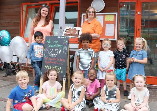 Staff Natasha Wells and Helen Marshall with children at the nursery