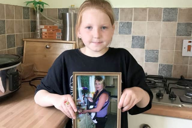 Grace Hutton, nine, from Cosham, is having her head shaved in memory of her mum Paula (in the picture frame)