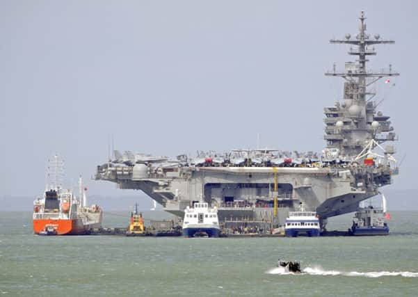 The USS George HW Bush at anchor in Stokes Bay, Gosport, Hampshire, England 

Picture: Malcolm Wells (170727-6460)