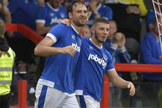 Brett Pitman celebrates his equaliser for Pompey with Conor Chaplin at Crawley. Picture: Neil Marshall