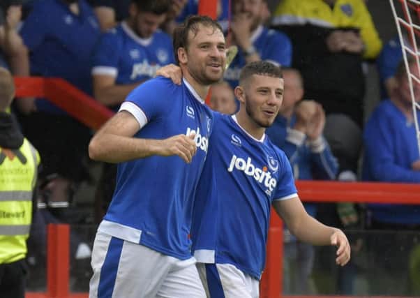 Brett Pitman celebrates his equaliser for Pompey with Conor Chaplin at Crawley. Picture: Neil Marshall