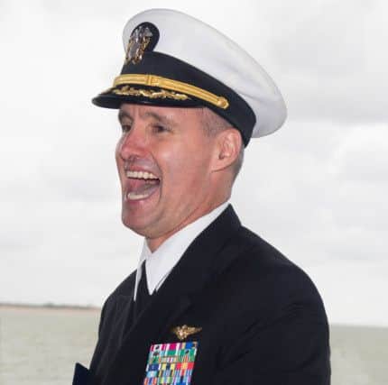 A commander of USS George H W Bush shares a joke with visitors to the warship.                           Picture: Mark Rutley