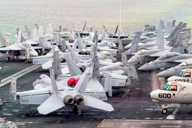 F18 Super Hornets swarm the flightdeck of USS George H W Bush in the Solent.     Picture: Mark Rutley