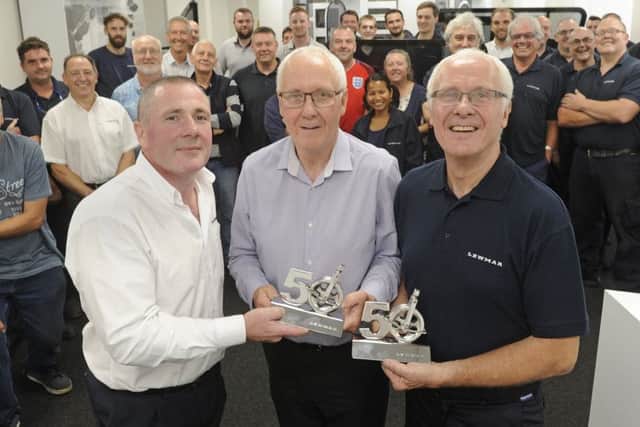 Lewmar's managing director Peter Tierney with (left), presents Chris and Michael Treagust with trophies for their 50 years service.
Picture: Ian Hargreaves (170933-1)