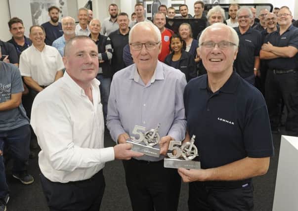 Lewmar's managing director Peter Tierney with (left), presents Chris and Michael Treagust with trophies for their 50 years service.
 Picture: Ian Hargreaves  (170933-1)