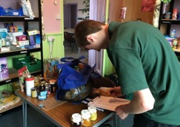 Helen Hitchings' son checking through a food bank donation