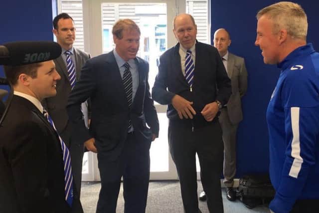 Michael Eisner, right centre, and his son Eric meet Pompey boss Kenny Jackett