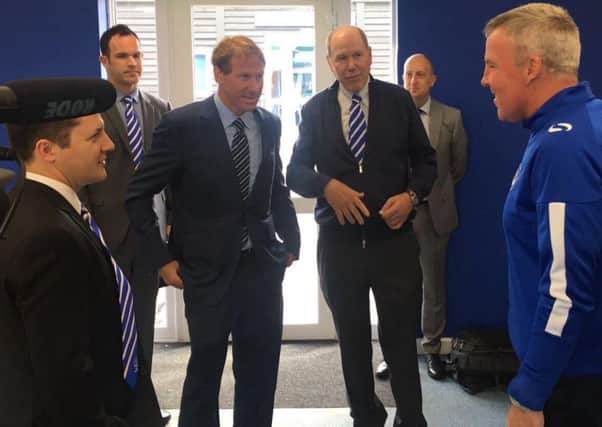 Michael Eisner, right centre, and his son Eric meet Pompey boss Kenny Jackett