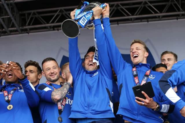 Gary Roberts lifts the League Two trophy. Picture: Joe Pepler