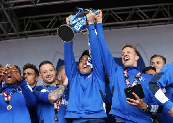 Gary Roberts lifts the League Two trophy. Picture: Joe Pepler