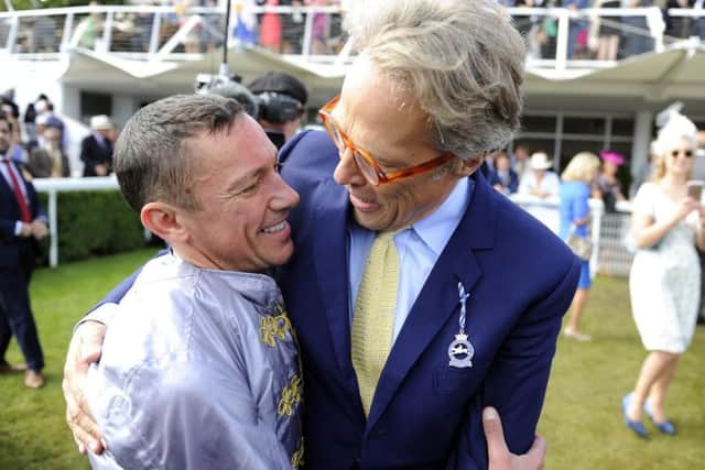 Frankie Dettori - whose two winners helped illuminate Friday and Saturday's racing at Goodwood - gets a hug from Lord March / Picture by Malcolm Wells