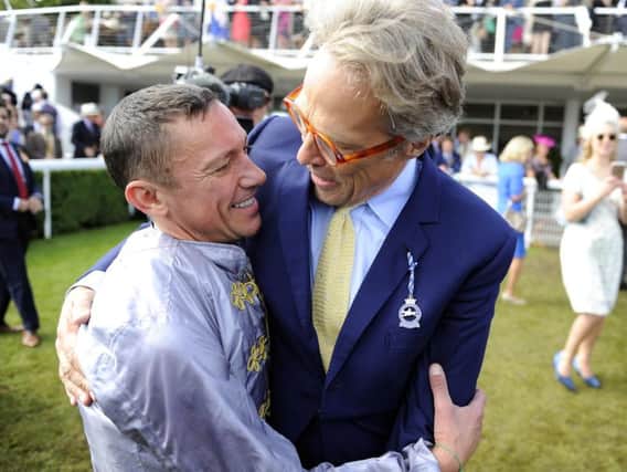 Frankie Dettori - whose two winners helped illuminate Friday and Saturday's racing at Goodwood - gets a hug from Lord March / Picture by Malcolm Wells