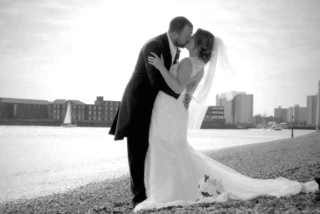 Terri and Stu Horn share a kiss on the beach in Old Portsmouth after marrying earlier this year. Picture: Mark Robbins Photography