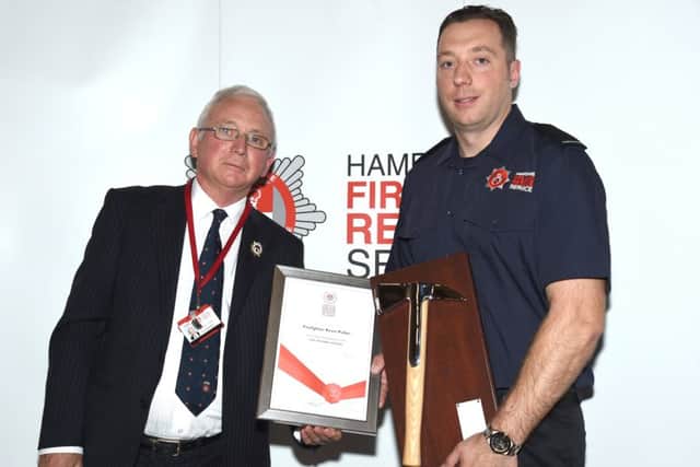 New firefighters graduating at Hampshire Fire and Rescue Service. Pictured: Kevin Pullen receiving the silver axe from Councillor Chris Carter