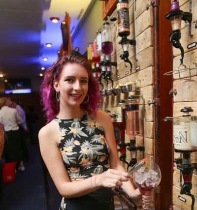 Sophie Good shows off the vast array of gins on display