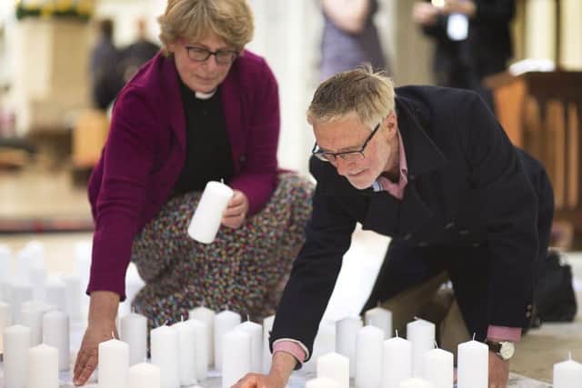 The Rev Jane Isaac and her husband David light candles Picture: Peter Langdown