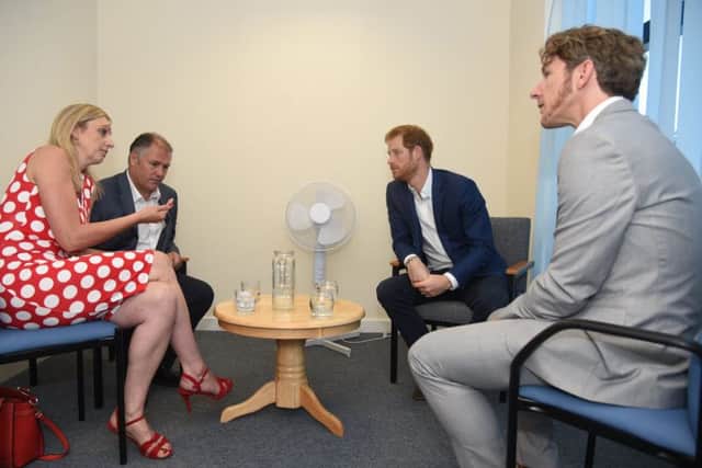 From left,
Jane and Jamie Gailer, Prince Harry and Dominic Hurley talk about the new ID cards Picture: Sarah Lucy Brown