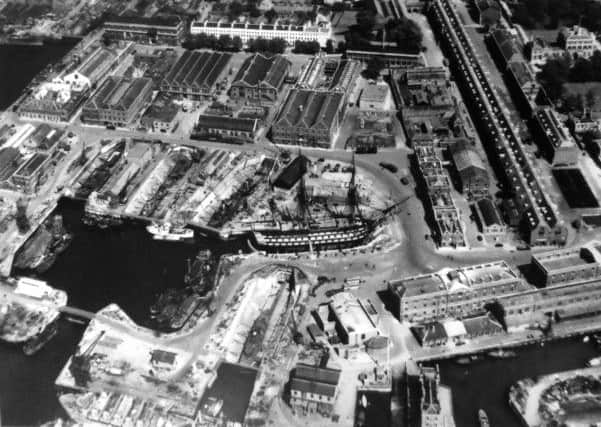 HMS Victory takes pride of place in this 1949 picture of Portsmouth dockyard.