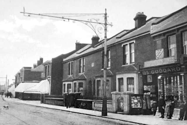 A quiet day in Fawcett Road, Southsea, with Mr Goddards newsagents. The shops with the blinds are on the corner of Jessie Road.  				                                          Picture: Robert James Collection
