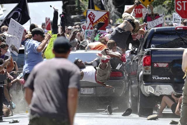 People fly into the air as a vehicle drives into a group of protesters demonstrating against a white nationalist rally in Charlottesville, Virginia, last weekend