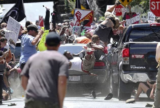 People fly into the air as a vehicle drives into a group of protesters demonstrating against a white nationalist rally in Charlottesville, Virginia, last weekend