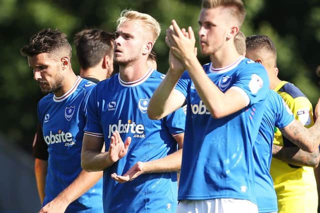 Jack Whatmough and Adam May show their appreciation to the Pompey fans who travelled to the Kassam Stadium on Saturday