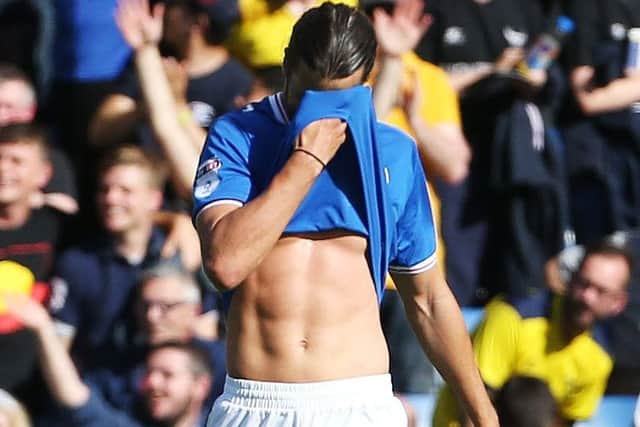 Christian Burgess attempts to hide his disappointment at the Kassam Stadium