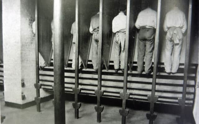 Inmates at Kingston Prison, Portsmouth, on the treadwheel which was abolished in 1898.