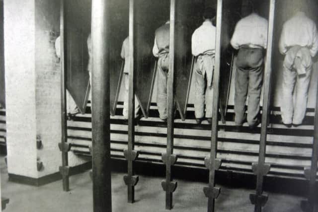 Inmates at Kingston Prison, Portsmouth, on the treadwheel which was abolished in 1898.