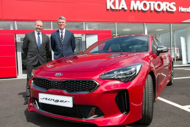 Hendy Group chief executive Paul Hendy (left) with Paul Philpott, President and CEO, Kia Motors (UK) at the opening of the new Kia Hendy showroom in Portsmouth with the new Kia Stinger  Picture: Mark Millwood