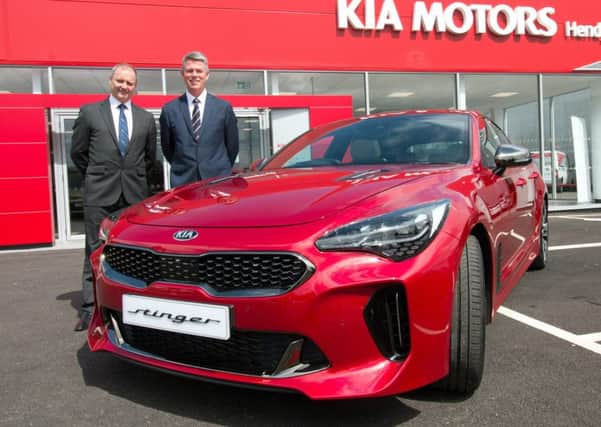 Hendy Group chief executive Paul Hendy (left) with Paul Philpott, President and CEO, Kia Motors (UK) at the opening of the new Kia Hendy showroom in Portsmouth with the new Kia Stinger  Picture: Mark Millwood