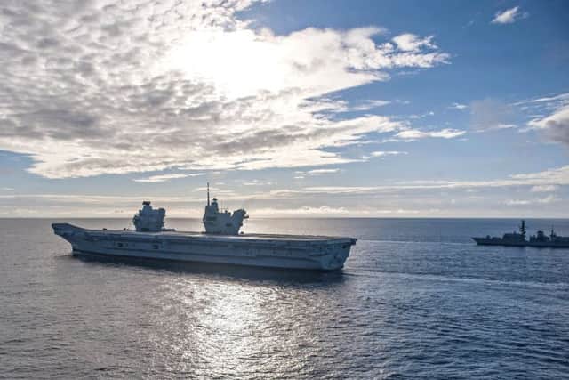 The Royal Navy aircraft carrier HMS Queen Elizabeth sails in formation with the Nimitz-class aircraft carrier USS George H.W. Bush during exercise Saxon Warrior 2017