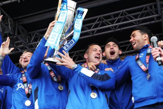 Michael Doyle lifts the League Two trophy