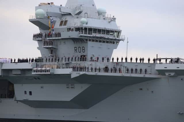 The ship's company of HMS Queen Elizabeth as the ship comes into Portsmouth Harbour