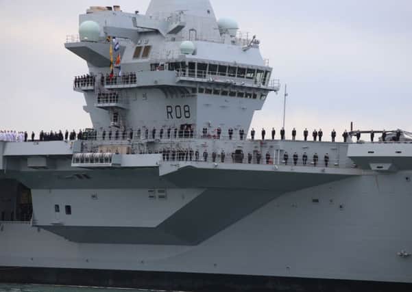 The ship's company of HMS Queen Elizabeth as the ship comes into Portsmouth Harbour