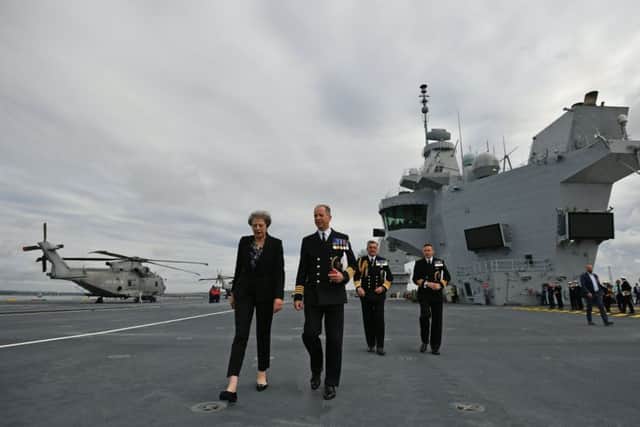 Prime Minister Theresa May talks to Captain Jerry Kyd, commanding officer of HMS Queen Elizabeth, which has arrived in Portsmouth Picture: Ben Stansall/PA Wire