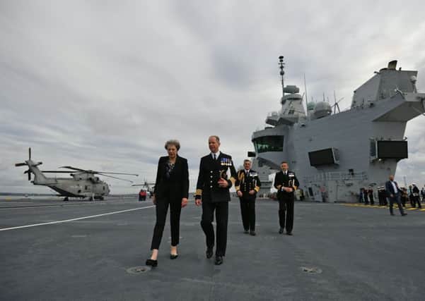 Prime Minister Theresa May talks to Captain Jerry Kyd, commanding officer of HMS Queen Elizabeth, which has arrived in Portsmouth Picture: Ben Stansall/PA Wire