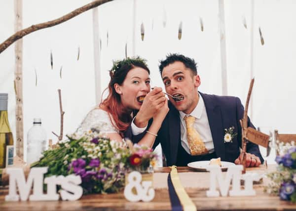 Emma Bazely and Sam Dean tuck into an Asda cheesecake at their wedding