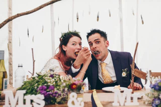 Emma Bazely and Sam Dean tuck into an Asda cheesecake at their wedding