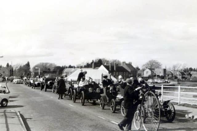 A penny farthing  leads  a convoy of  vintage cars across Hayling bridge to celebrate the abolition of tolls in April 1960.