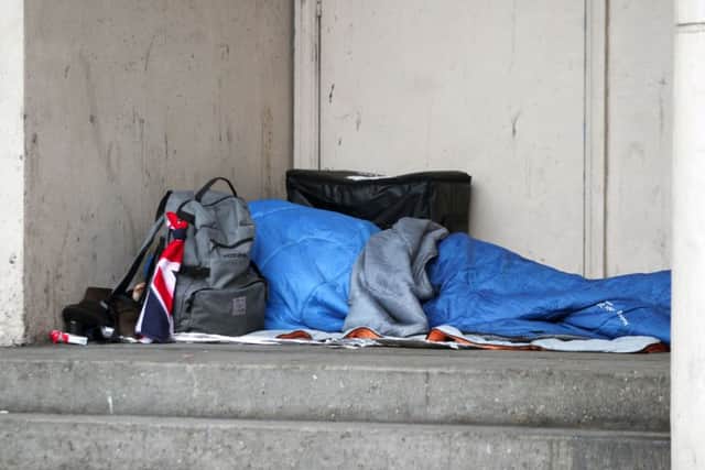 A homeless person sleeping rough in a doorway