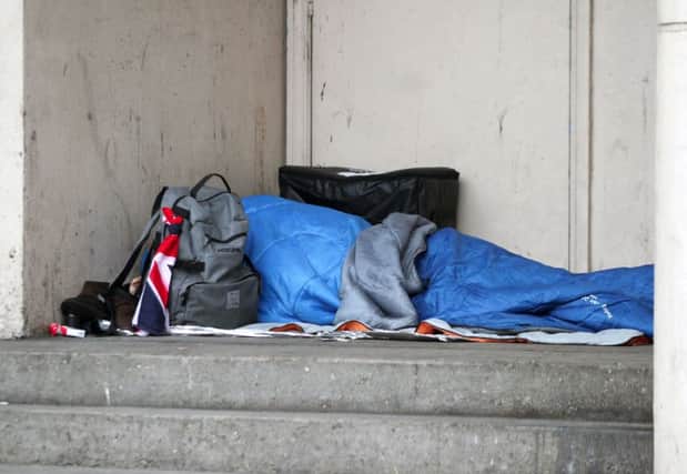 A homeless person sleeping rough in a doorway