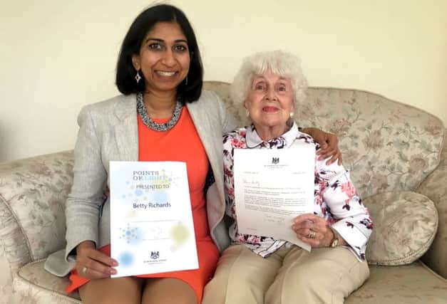 Fareham MP Suella Fernandes presenting Betty Richards with her Points of Light award from the Prime Minister