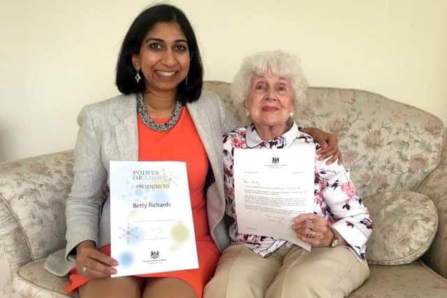 Fareham MP Suella Fernandes presenting Betty Richards with her Points of Light award from the Prime Minister