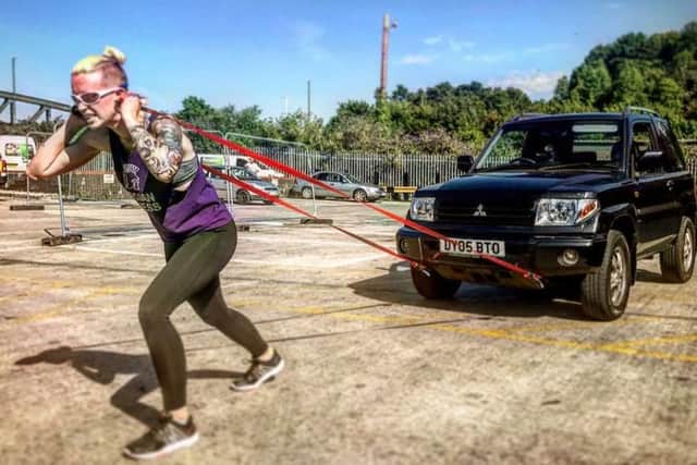 Vicky Clissett pulling her car as she trains for the big day