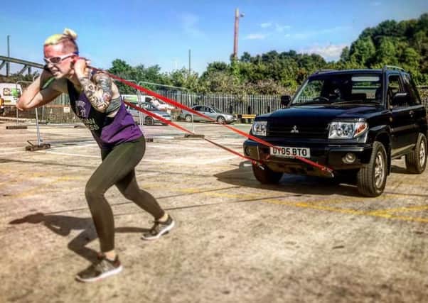 Vicky Clissett pulling her car as she trains for the big day