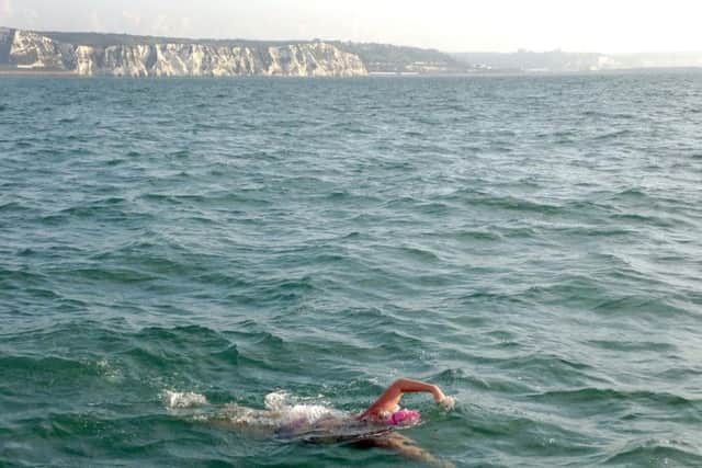Deborah Herridge during her Isle of Wight swim, with the White Cliffs of Dover in the background. PPP-170913-094637001